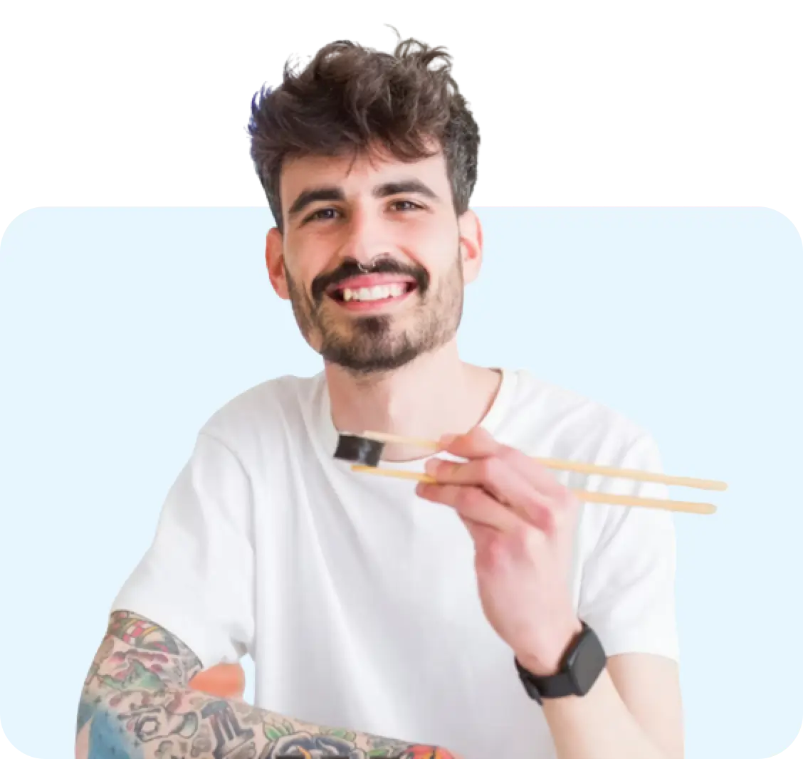 Image of a man eating with chop sticks.